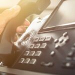 Person picking up a phone to call