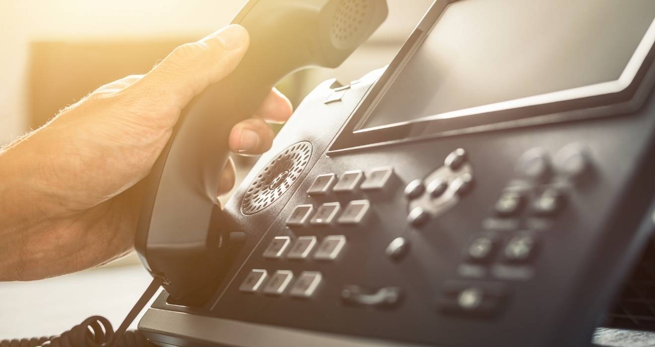 Person picking up a phone to call